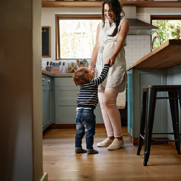 mother and toddler dancing in a kitchen