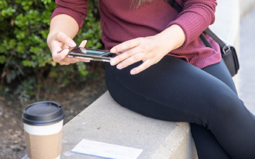 a person taking a photo of check and coffee in the bottom left corner