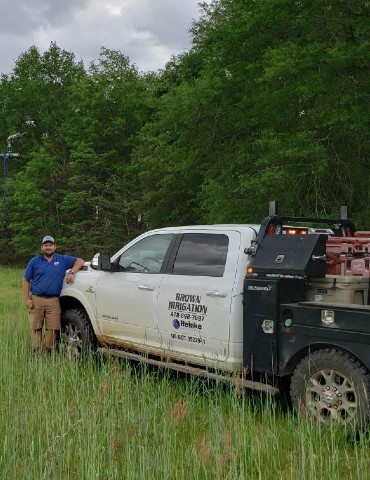 brown irrigation truck with worker